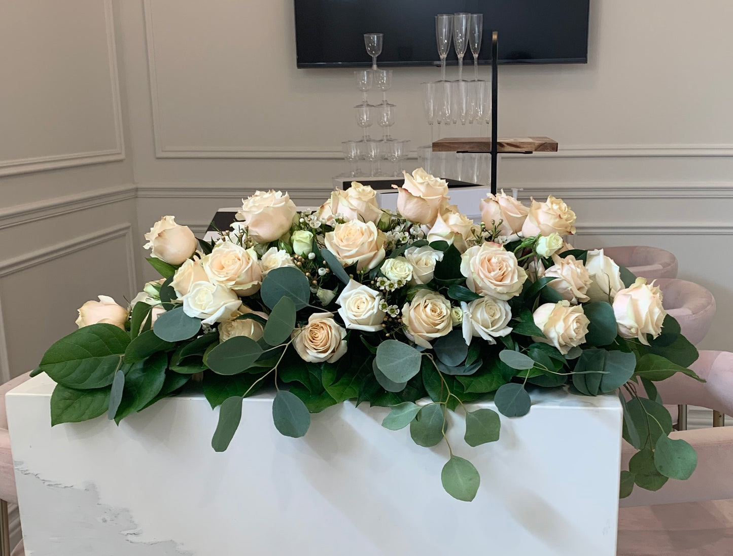 Floral arrangement on a marble surface with a neutral background