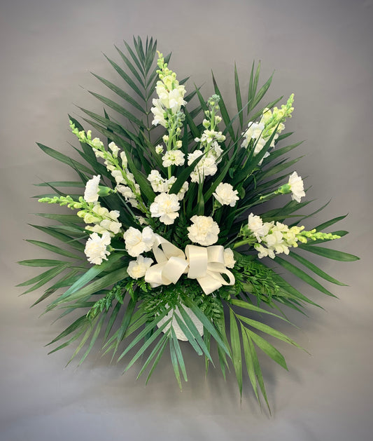 Honour your loved ones with a fresh flower tribute basket delivered to the funeral home or ceremony venue, made with snapdragons, roses and carnations. Next day delivery to North York, Scarborough, Greater Toronto Area