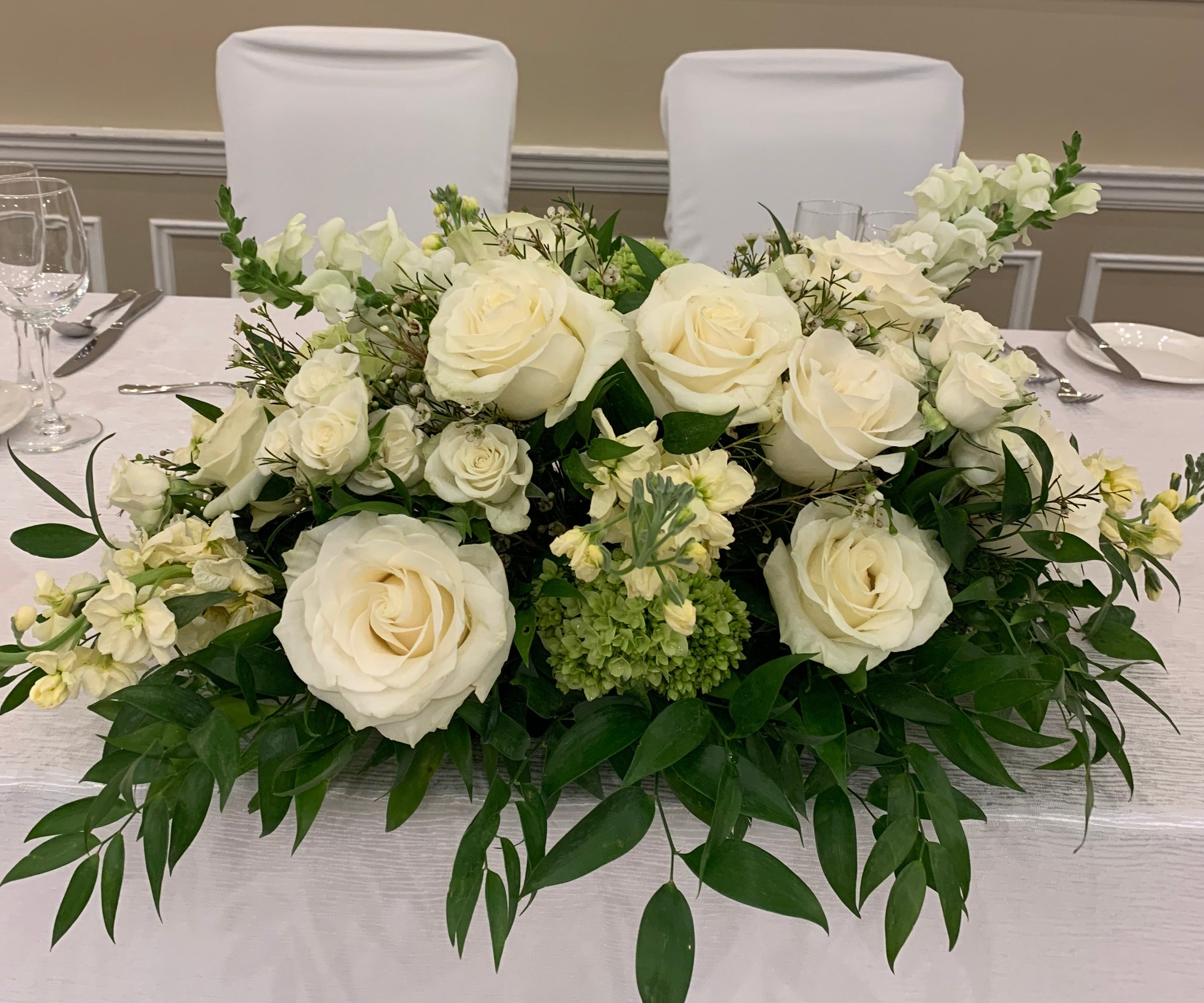 Wedding head table florals white and green 