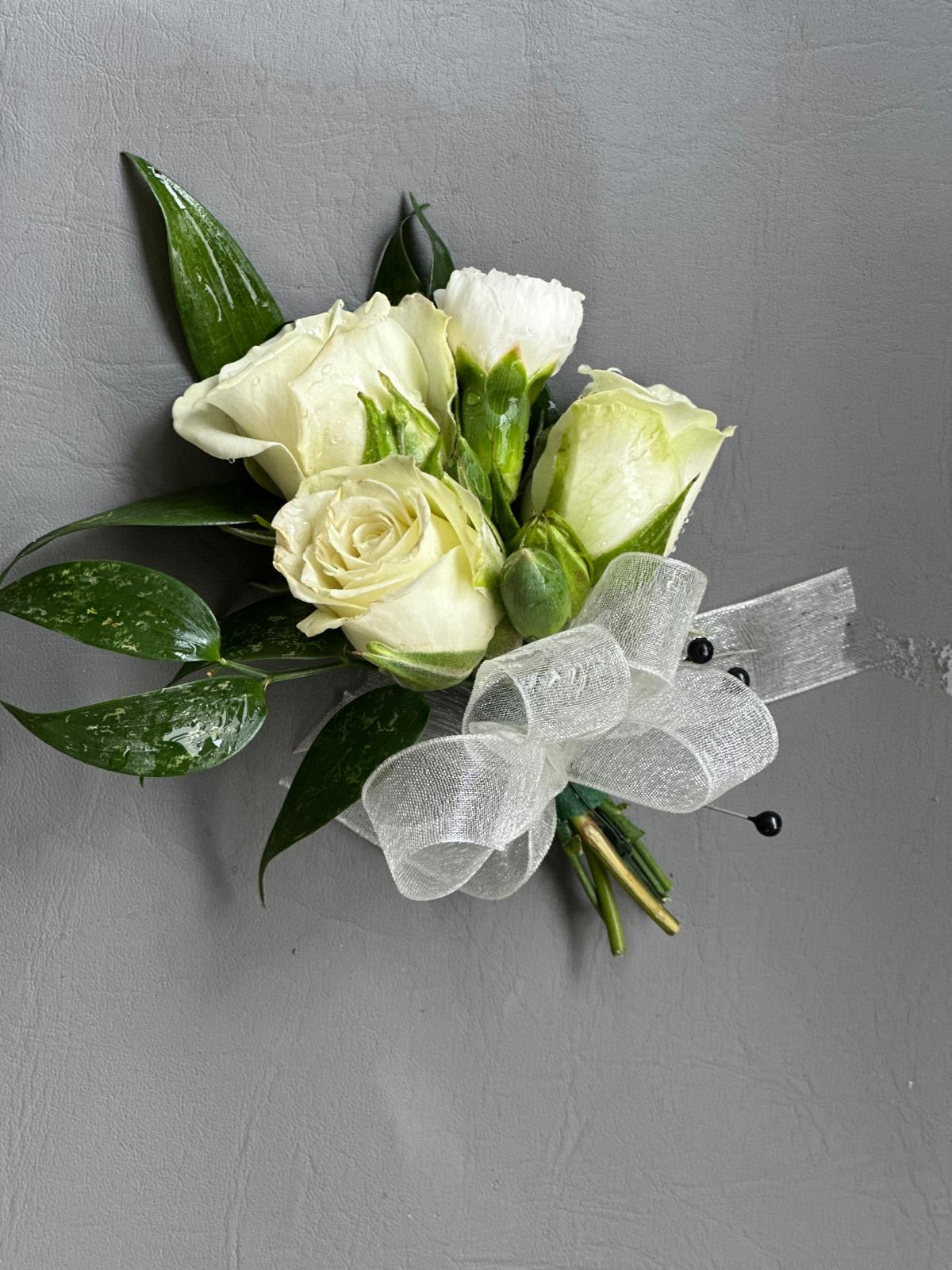 White boutonniere with spray roses and white ribbon for wedding or event delivery in North York Scarborough Markham and Toronto
