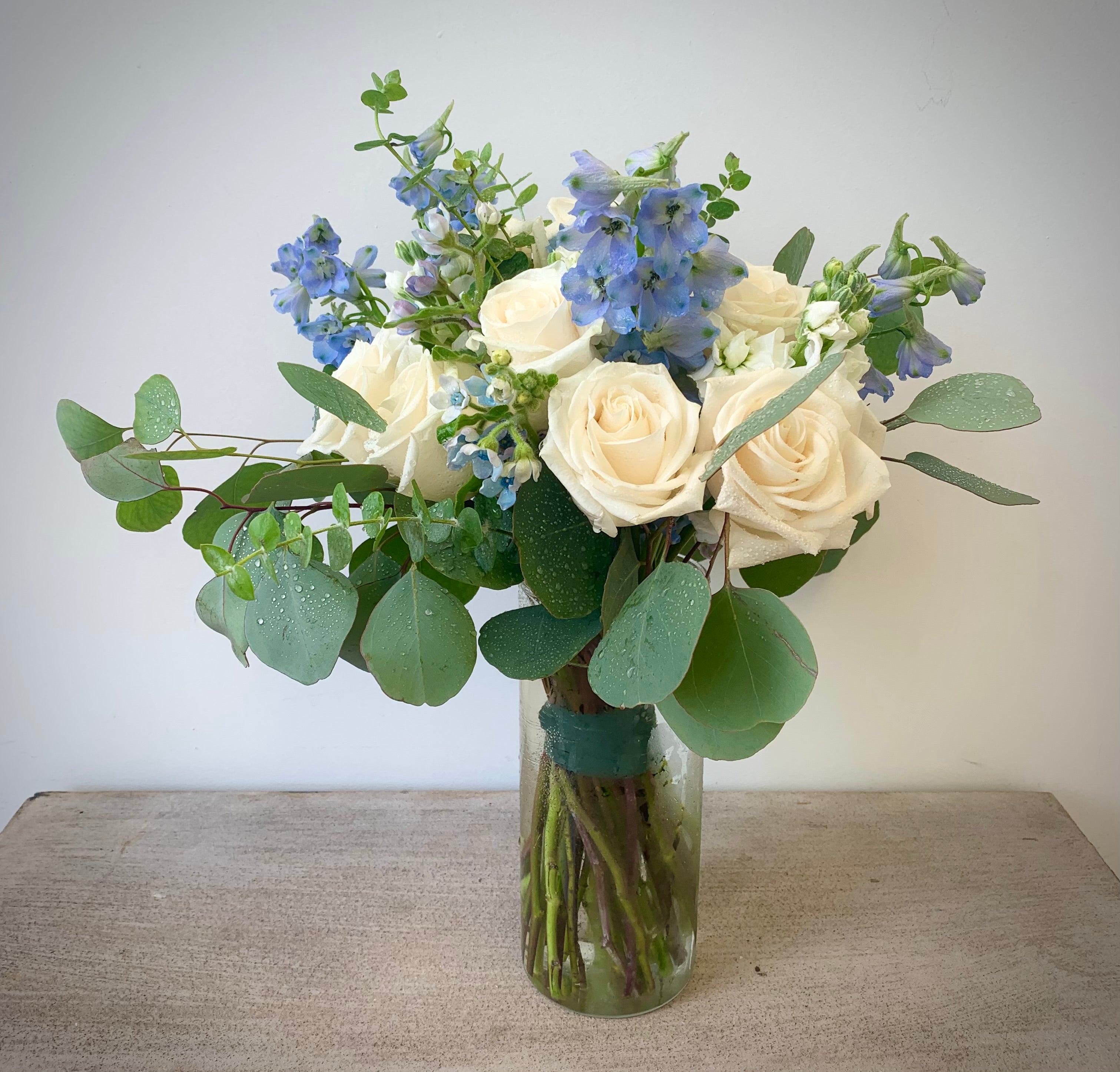 White and blue bridal bouquet with blue Tweedia eucalyptus and white roses, for outdoor wedding at The Vue in Etobicoke